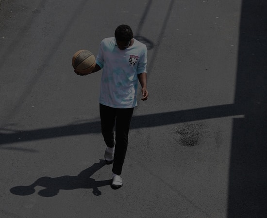 Youth walking down the street with a basketball